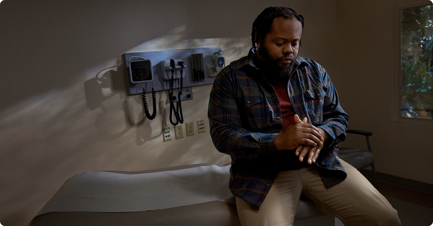 Man sitting in exam room rubbing his hands together