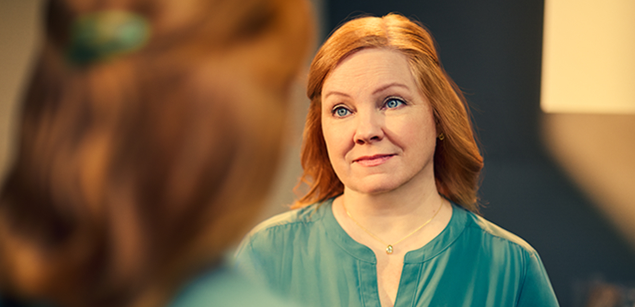 Patient listening to nurse blurred in foreground