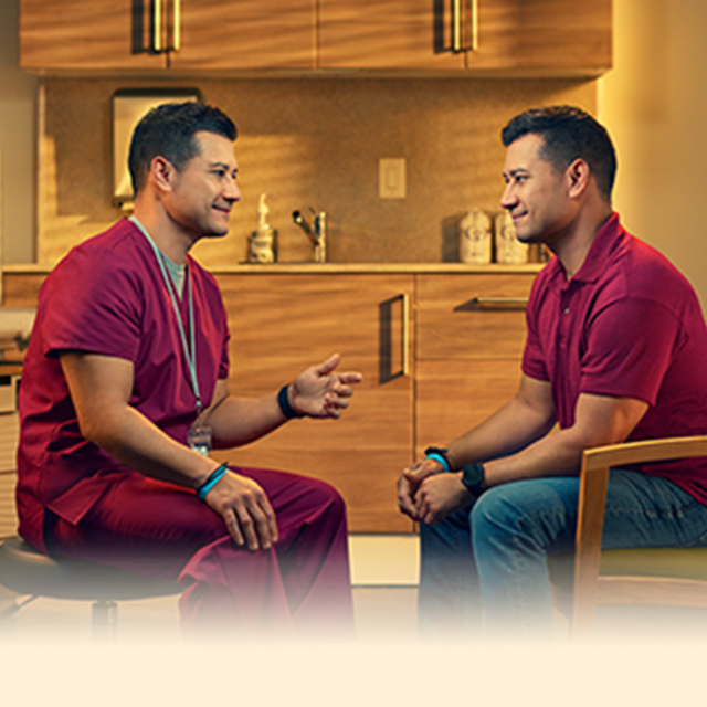 Doctor and patient sitting and facing one another in exam room