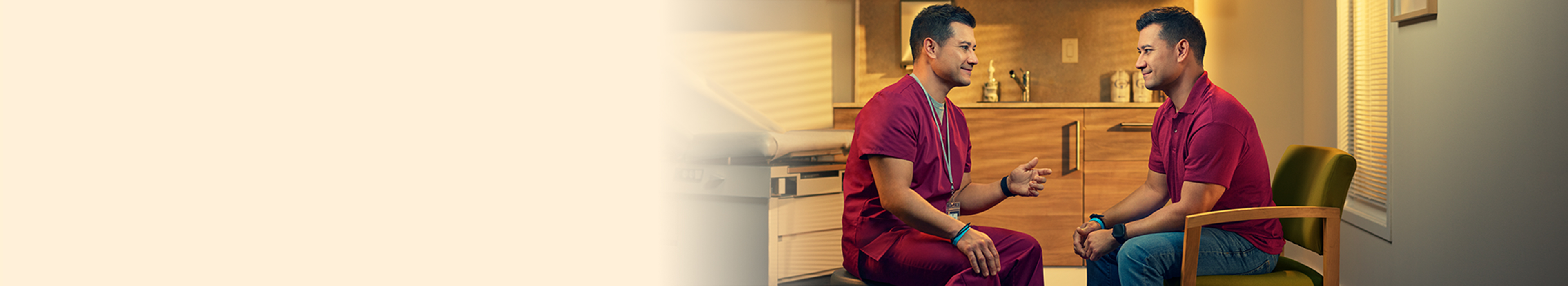 Doctor and patient sitting and facing one another in exam room